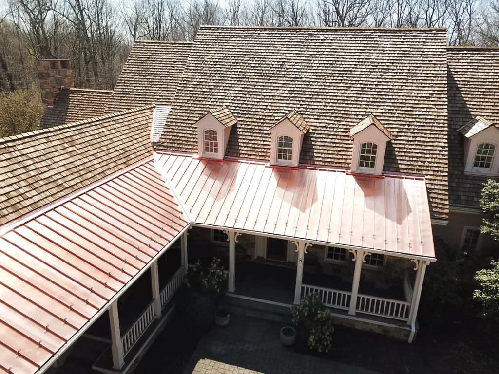 New cedar shake roof with copper standing seam porch roofing on a home on Maryland's Eastern Shore