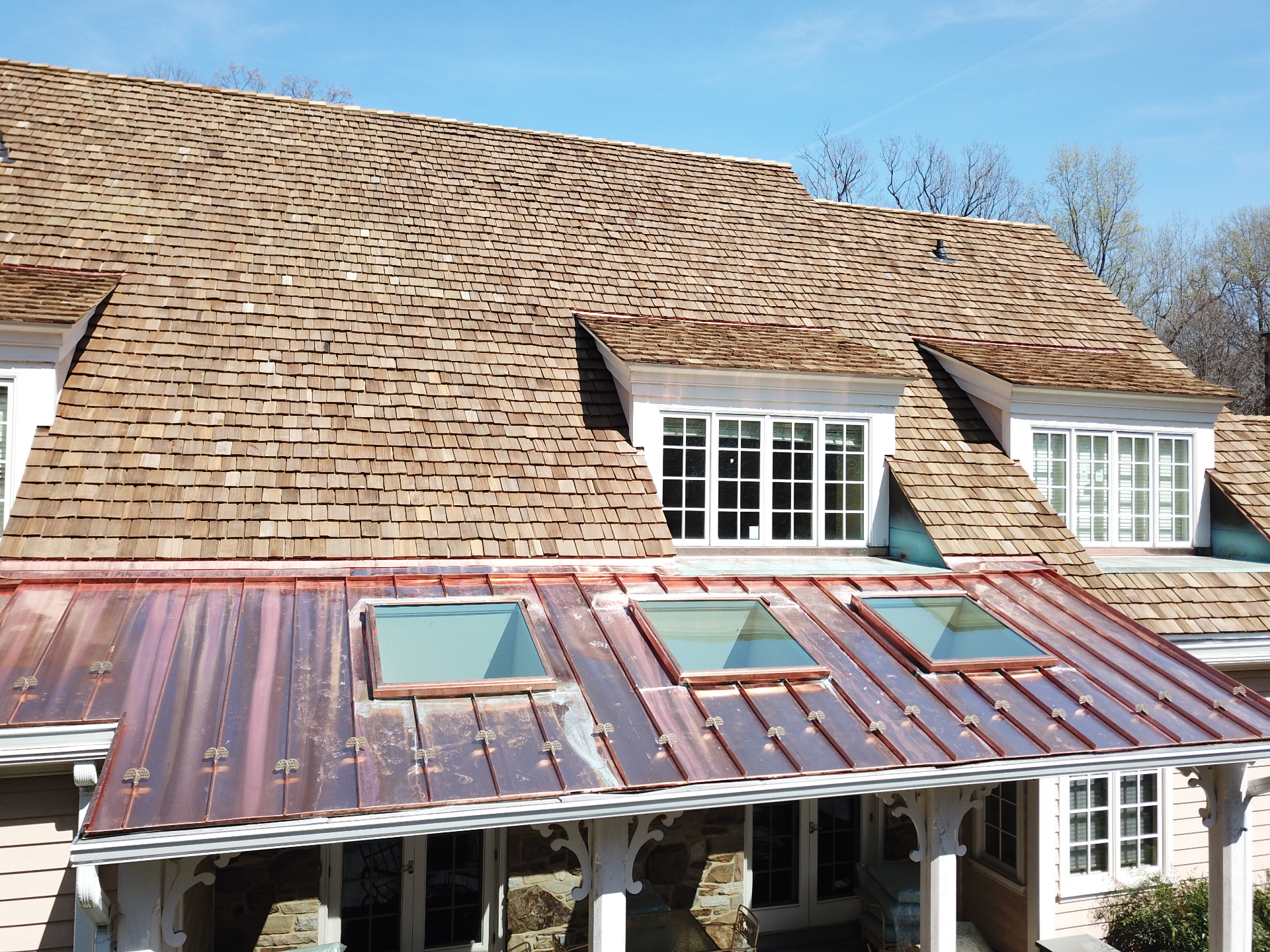 Cedar shake roof with copper roof and skylights
