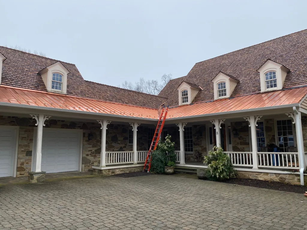 Stone home with a new cedar shake roof and copper porch roofing on Maryland's Eastern Shore