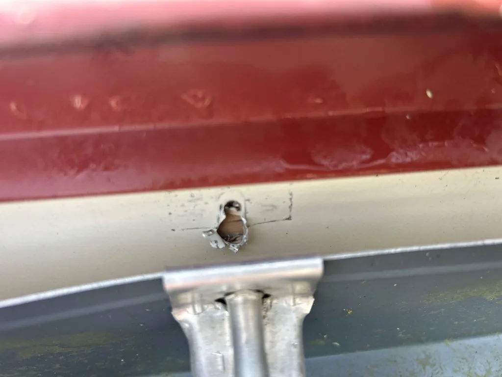 Snapped gutter hanger caused by snow and ice buildup — needs repair