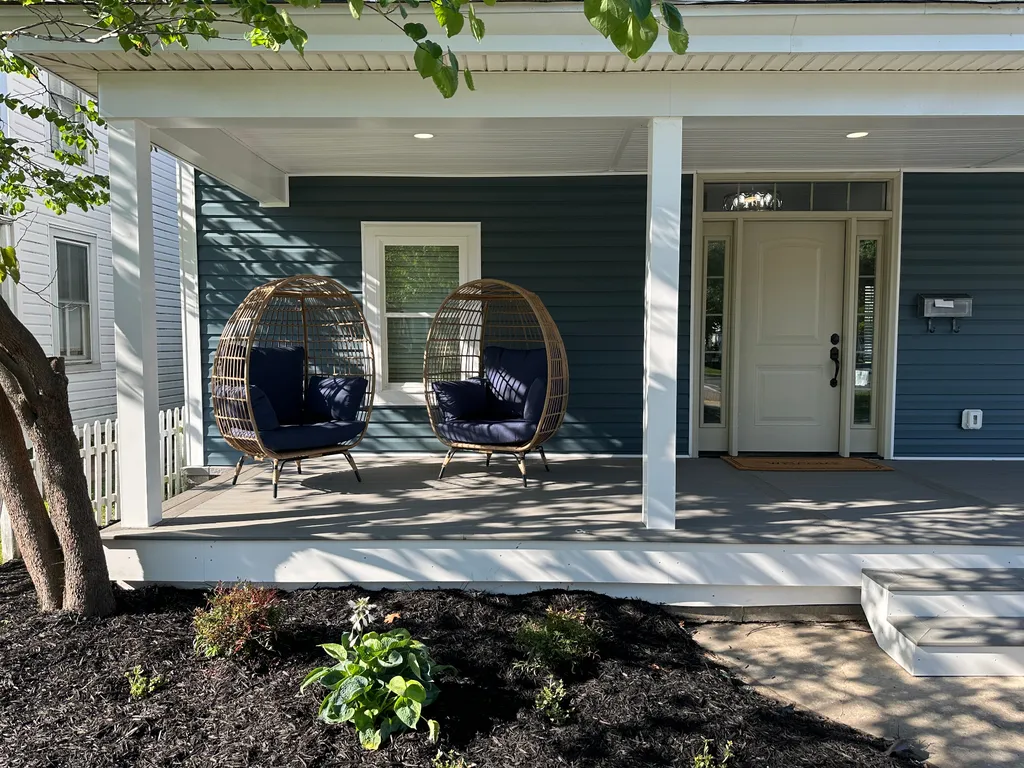 New blue lap siding, white trim and porch ceiling on a home in Cambridge, Maryland
