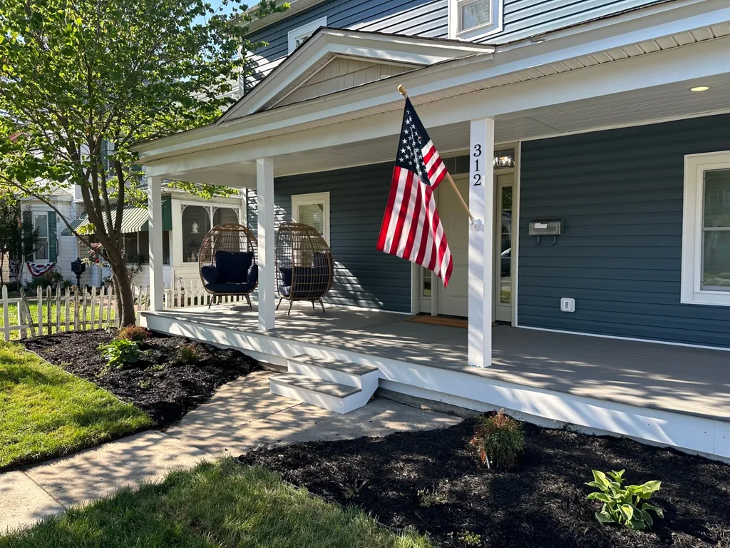 Vinyl siding with white trim — front porch detail