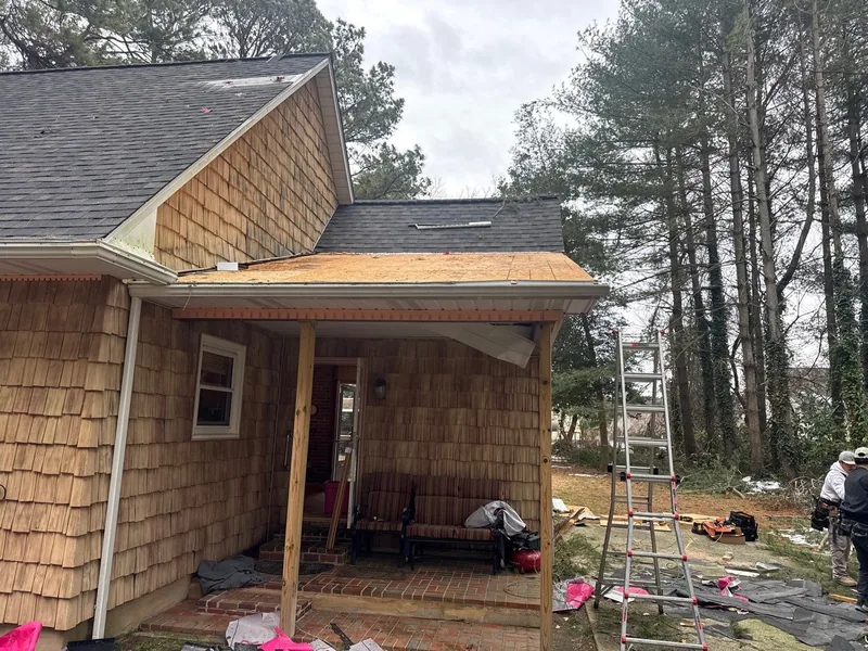 New decking installed on the porch roof during the repair